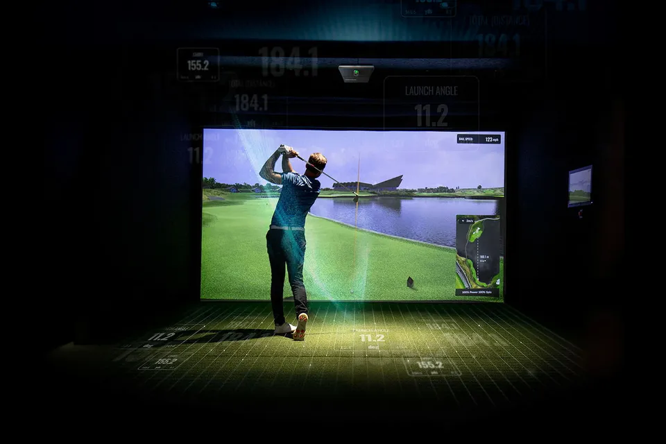 Golfer mid-swing in a finished golf simulator
