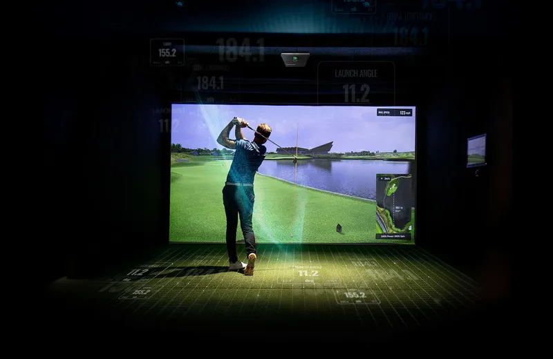 Golfer in action in a finished golf simulator