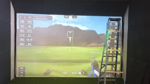 Projected driving range and launch-monitor data during golf simulator equipment setup