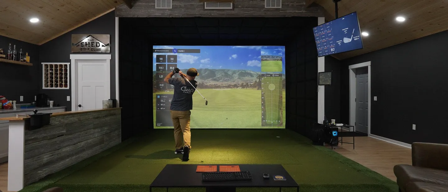 Finished golf simulator room running a Foresight Sports launch monitor